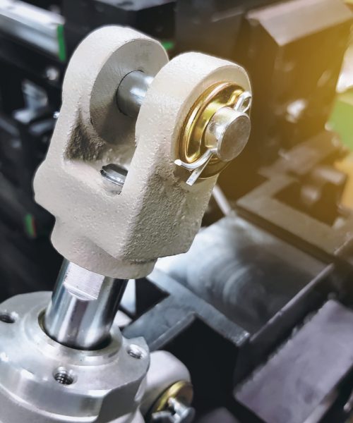 Close-up Rod Clevis of Pneumatic Cylinder on Blurred Machine Background