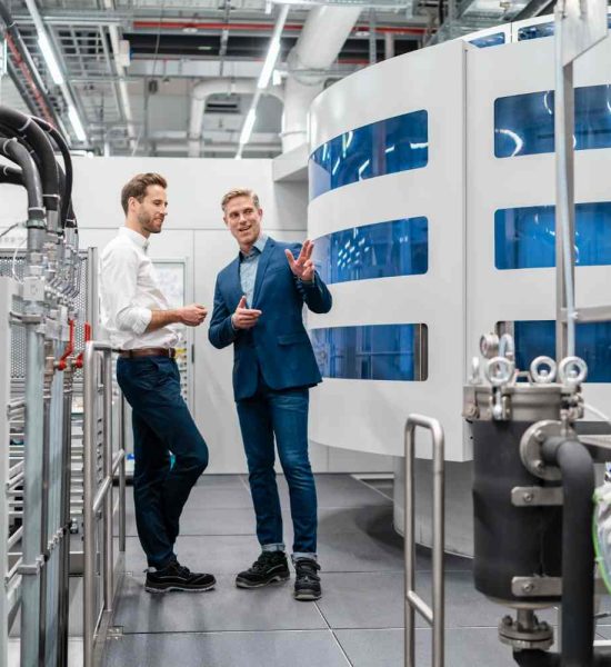 two-businessmen-talking-in-a-modern-factory-2026-01-05-00-33-53-utc (1)